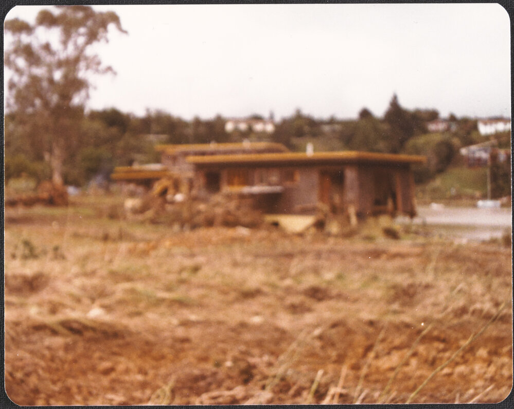 Debris up against house at Waipapa Landing